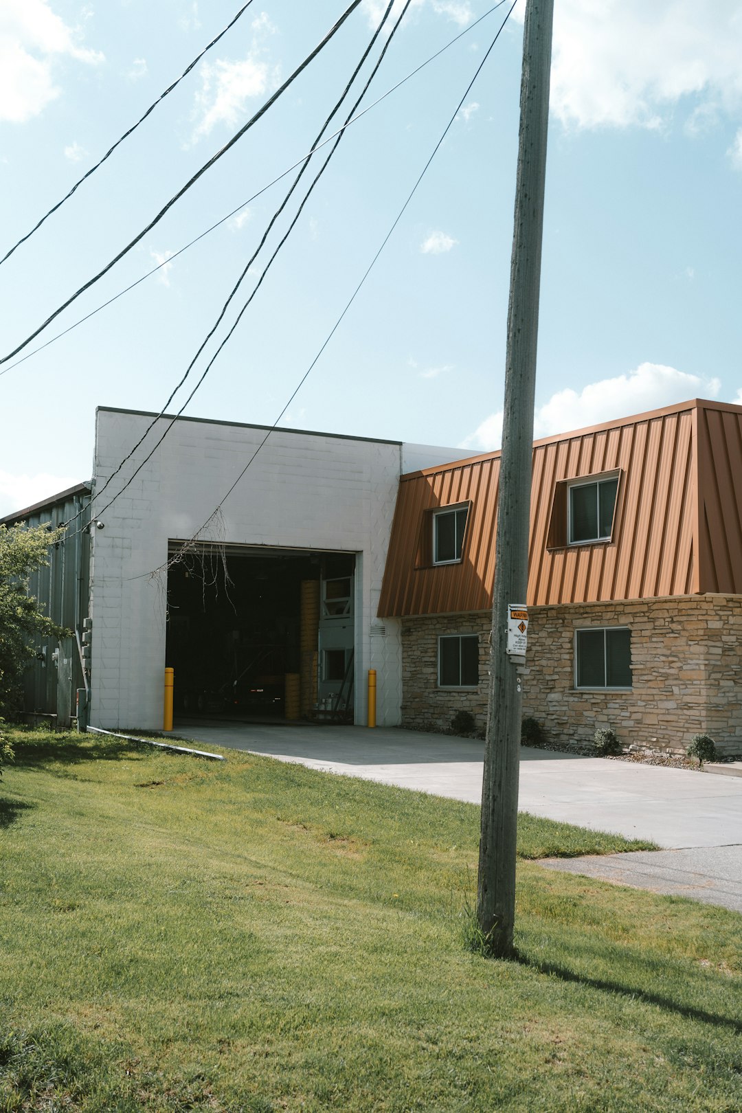 gallery-1 a-building-with-a-metal-roof-next-to-a-street-tgce2gdjamq